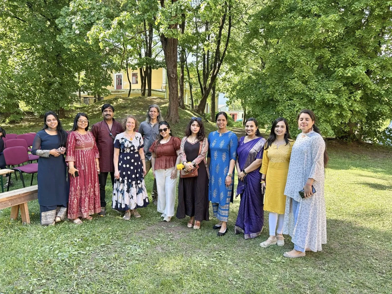 IAE volunteers in Indian dress with guests on the lawn of Tiigi Seltsimaja